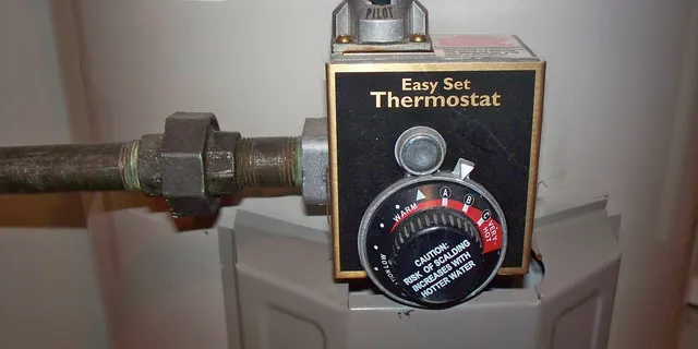 The temperature dial on the front of a gas water heater